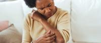 Woman scratching arm.